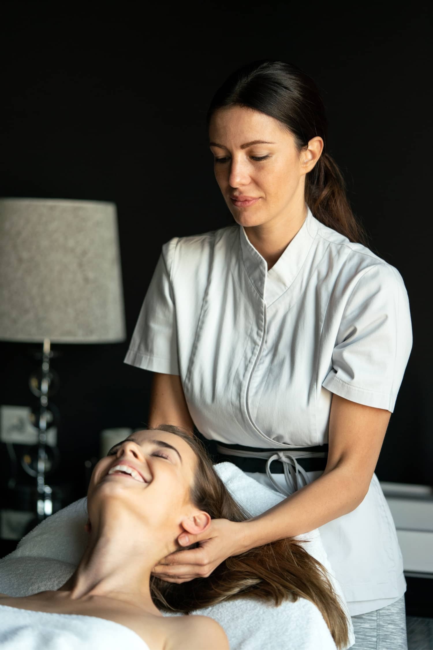 A guest relaxing during a warm herbal massage treatment at Ancient Herbal Spa